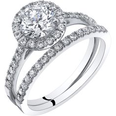 a white gold ring with diamonds on the band and an oval shaped diamond in the center