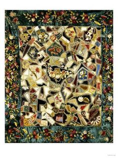 an intricately designed quilt with many different colors and designs on the front, along with flowers