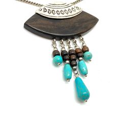 Unusual Faux Turquoise and Silver Drop Dangle Pendant and Chain I fell. in love with the design of this necklace It really looks like 925 Silver ( the jury is out on that) It has a main shape in what seems to be Ebony  well a hardwood in any case from which dangle five ornamental droppers that terminate in the turquoise beads The pendant measures 5.1 cm by 6.7 cm  The Chain is 18 inches long Selling as Silvertone since there is no 925 mark In Fine Vintage Condition 🎀Thank you so much for lookin Turquoise Dangle Nickel-free Necklace, Turquoise Dangle Necklace Nickel Free, Dangle Necklaces With Large Pendant, Large Letters, Turquoise Beads, Pendant Necklaces, Pendant Jewelry, Jewelry Necklace Pendant, 925 Silver