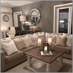 a living room filled with lots of couches and candles in front of a mirror