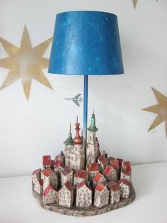 a lamp that is sitting on top of a table next to a star shaped wall