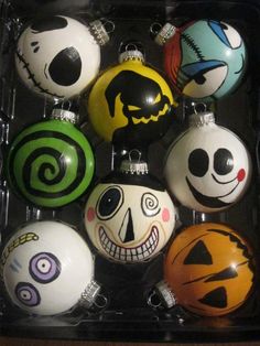 a box filled with halloween ornaments in different colors and designs on each ornament