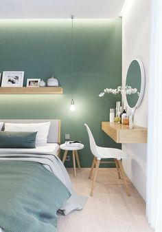 a bedroom with green walls and white furniture