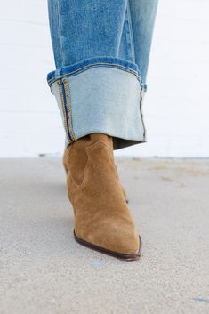 Indulge in the luxurious softness of suede. This casual brown suede Bootie boasts a slender block heel, pointed toe, and convenient pull straps, making it a timeless cowboy-inspired design with a sophisticated urban edge that will awaken your inner outlaw. Leather Suede Upper & Manmade Materials Pull-Up Tabs 1.75" Heel Everyday Earrings Studs, Brown Suede Boots, Hair Accessories Jewelry, Fancy Pants, Handbag Shoes, Suede Booties, Brown Suede, Suede Boots, Denim Pants