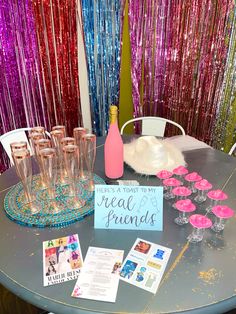 a table topped with lots of wine glasses next to a sign that reads, there's a toast to my real friends