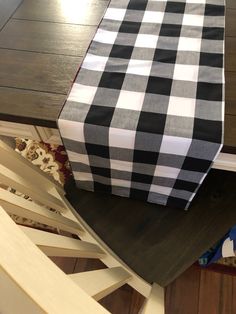 a black and white checkered table runner sitting on top of a wooden table