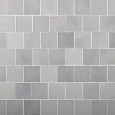 a white and gray tiled wall with no one in the photo or description on it