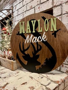 a wooden sign that says waylon mack with an image of a deer on it