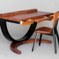 a wooden desk with two chairs underneath it