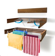 two wooden shelves with towels hanging from them