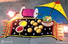 a table with some food on it and an umbrella next to it, sitting on the ground