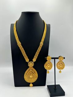 Indulge in the rich heritage of South Asia with our captivating necklace, a dazzling fusion of Indian, Pakistani, and Nepali influences. Inspired by the opulence of traditional jewelry, this exquisite piece showcases intricate craftsmanship and vibrant gemstones, reminiscent of royal adornments from the subcontinent. Embellish your neckline with its enchanting design, meticulously crafted to capture the essence of South Asian splendor. Elevate your style and embrace the cultural tapestry of Indi Gold Traditional Jewelry Sets For Formal Occasions, Gold Plated Jewelry Sets For Formal Diwali Occasions, Temple Jewelry Sets For Celebration, Yellow Gold Round Jewelry Set For Festive Occasion, Formal Gold Plated Jewelry Sets For Diwali, Festive Yellow Gold Jewelry Set With Round Shapes, Festive Formal Gold Plated Jewelry Sets, Festive Yellow Gold Round Jewelry Set, Temple Jewelry Sets With Elegant Design