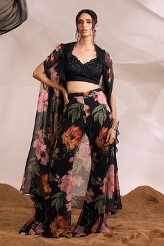 Black ruffled cape with all-over floral prints. Comes with coordinating printed flared pant and floral embellished blouse. - Aza Fashions Cape Set, Black Cape, Embellished Blouse, Indian Couture, Blazer Set, Blouse Sleeveless, Wedding Service, Black Ruffle, Bride Bridal