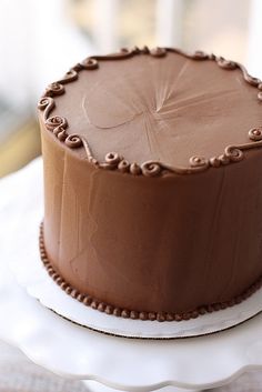 a chocolate cake sitting on top of a white plate