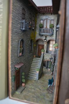 a doll house is shown with stairs leading up to the second floor and another room on the other side