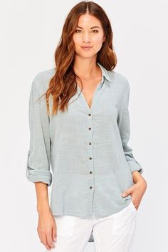 This 100% cocoon gauze cotton button up blouse is great worn alone or for layering. It features tabbed sleeves for easy rolling, a curved hem line and a box pleat on back. Cocoon Gauze - 100% Cotton. Front length: 25" Back length: 31" Preshrunk. Machine washable. Imported. Hem Leggings, Spring Blouses, Pretty Blouses, Contemporary Outfits, Button Up Blouse, Lifestyle Clothing, Box Pleats, Cropped Leggings, Cropped Pants