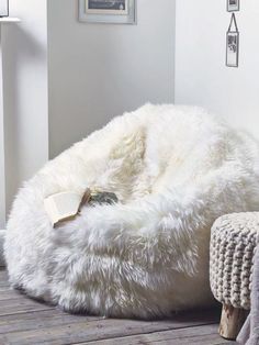 a white bean bag chair sitting on top of a wooden floor