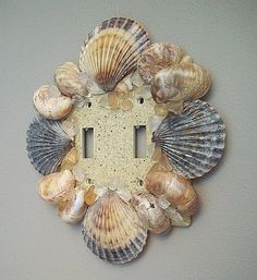 there is a light switch cover made out of seashells