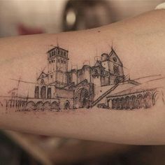 a drawing on the arm of a person with a building in the background and stairs leading up to it