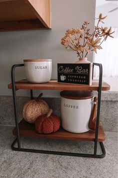 two coffee mugs are sitting on a shelf