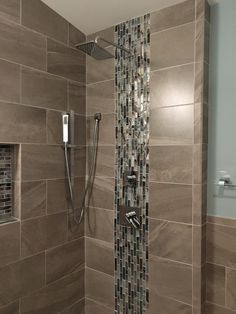 a shower with tiled walls and flooring in a bathroom