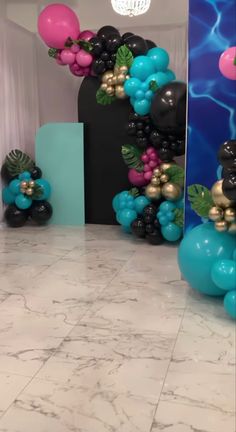 some balloons are in the shape of flowers and leaves on a marble floor with blue walls