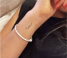 a woman with a small tattoo on her wrist