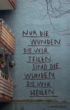 graffiti on the side of a building with words written in german and english below it