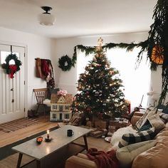 a living room filled with furniture and a christmas tree