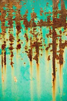 an old rusted metal surface that has been painted green