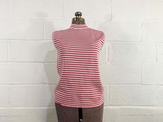 Chest: 36", stretches up to 44" Bottom Hem: 36", stretches up to 50" Length: 24" Material: no tag but it feels like acrylic Brand: no tag Killer sleeveless mockneck striped pink and white top. Zipper at the back neckline. Super cute an in great condition with a few snags in the fabric. Fabric has a ton of stretch. ✂ All garments measured laying flat. Bust, waist, & hip measurements are already doubled. Please refer to the last photo for the size chart I use to determine modern sizing. ✂ All items are vintage and pre-loved. All major flaws are listed, but small blemishes like loose stitches and buttons may not be in the item description as they are to be expected when purchasing vintage items. ♡ New items are listed every week! Follow instagram.com/checkenginevintage for the latest listings Retro Stretch Tank Top, Jay Walker, Follow Instagram, Striped Knit, White Top, White Tops, Womens Clothing Tops, Mock Neck, Pink White