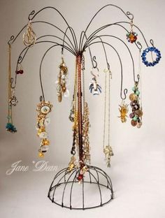 there is a metal tree with many necklaces on it