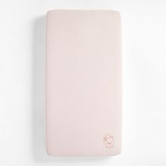 a pink baby crib mattress on a white background