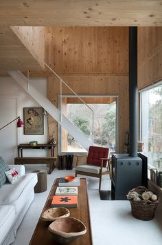 an instagram photo of a living room with wood paneling on the walls and stairs