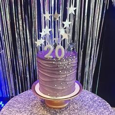 a purple cake sitting on top of a table