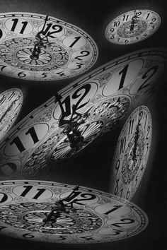 black and white photograph of clocks with numbers on them