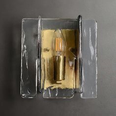 an open box with two candles inside of it on top of a gray countertop