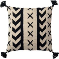 a black and white pillow with tassels on the sides, one side has an arrow