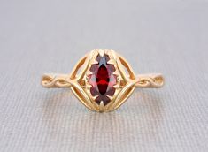 9k gold Celtic knot marquise red garnet engagement ring Flame Fusion Garnet size 10x5mm approx. marquise shape brilliant excellent cut 9k solid yellow gold garnet ring for women The ring dimensions are: front width: 12 mm/ 0.47" inch front height above the finger: 4.5mm/0.17" inch approx. side thickness: 1.7mm/0.06" inch side width: 3mm/0.11"inch back thickness: 1.4mm/0.05" inch back width: 2.4mm / 0.09" inch approx.   💎 OUR SHOP💎  https://www.etsy.com/shop/ClanTora 💍 RING 💍 SIZE *This Ring Garnet Engagement Ring, Garnet Rings, Red Garnet, Celtic Knot, White Roses, Ring Verlobung, Wedding Rings Engagement, Types Of Metal, Garnet