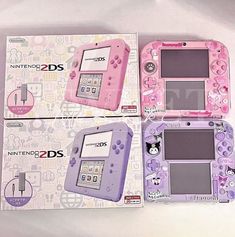 two pink and purple nintendo 3ds games consoles