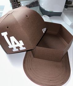 a baseball cap with the los angeles dodgers logo on it sitting on top of a table