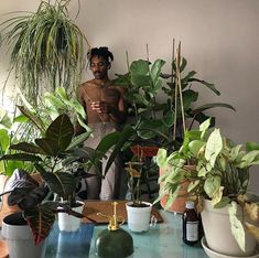 a man standing in front of potted plants