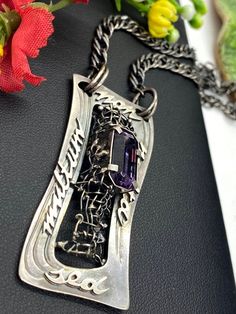 "ARTISAN AMETHYST PENDANT Hand-made Sterling Silver. Stones used: Amethyst. Height - 2\", Width - 7/8\" Chain - 22\" Unique Handcrafted One-of a-kind Design Pendant. Each Piece of Jewelry in my Collection is One of a kind. When you start wearing a piece of my jewelry you will fall in love with it more and more each day and feel that good energy that I pass into it while creating this piece of Art. I use only natural unique stones and unique technics creating my jewelry. You will be the only pers One Of A Kind Silver Amethyst Jewelry, One Of A Kind Purple Pendant Jewelry, One-of-a-kind Purple Pendant Jewelry, Artistic Purple Pendant Jewelry, Unique Jewelry With Large Purple Pendant, One-of-a-kind Amethyst Jewelry As Gift, One Of A Kind Amethyst Jewelry Gift, Unique Purple Jewelry With Large Pendant, Purple Sterling Silver Fusion Jewelry