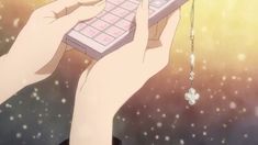 two hands holding a computer keyboard in front of a sky with stars and clovers