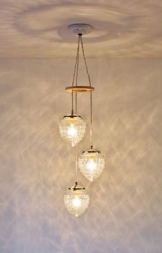 three lights hanging from the ceiling in a room