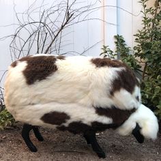 a fake cow that is standing in the dirt