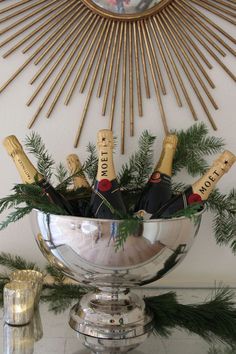 a silver bowl filled with bottles of champagne