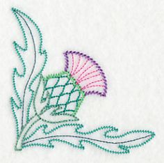 an embroidered design on white fabric with green and pink flowers