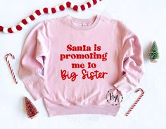 'SANTA IS PROMOTING ME TO BIG SISTER' SWEATSHIRT - a fun and festive sweatshirt for Big Sister to announce the BIG NEWS!! <3 Pink fleece sweatshirt with red vinyl font (As-is design. Personalization is not available) HOW TO ORDER: * Select A Size * Select Your Quantity * Add to Cart ("buy now" will take you directly to checkout | "add to cart" will allow you to continue shopping) SWEATSHIRT MATERIAL: * 60% Cotton / 40% Polyester Fleece All items are handmade from professional, quality materials, Big Sister Christmas Shirt, Christmas Big Sister Announcement, Big Sister Announcement Christmas, Big Sister Christmas Announcement, Big Sis Announcement, Big Sister Announcement Shirt, Big Sister Announcement, Cute Bodysuits, Sister Christmas