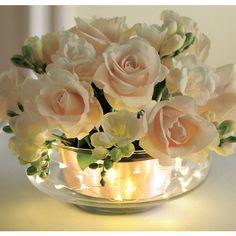 a vase filled with white flowers on top of a table